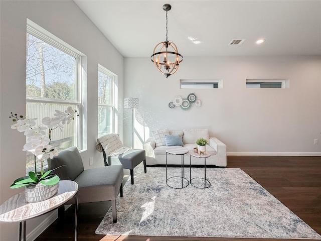 interior space featuring dark wood-type flooring and an inviting chandelier