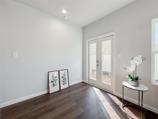 entryway with dark hardwood / wood-style flooring and french doors