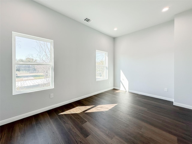 empty room featuring dark hardwood / wood-style flooring