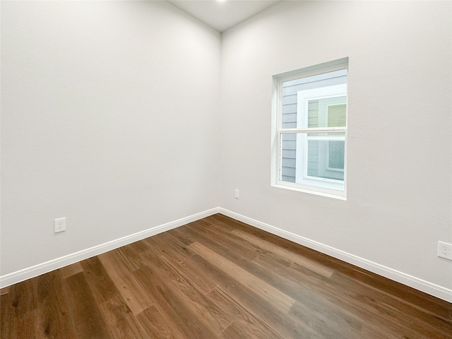 empty room with hardwood / wood-style flooring