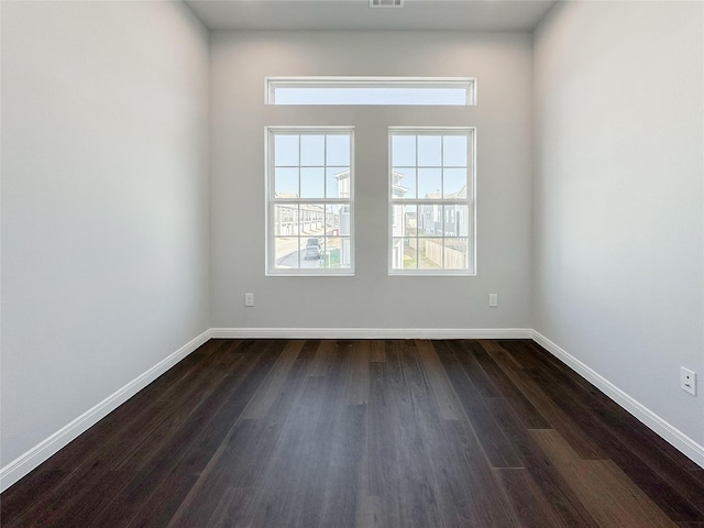 unfurnished room with dark hardwood / wood-style floors