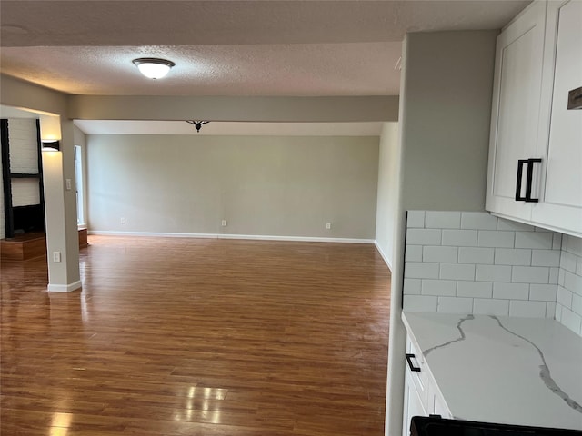 interior space featuring a textured ceiling and dark hardwood / wood-style flooring