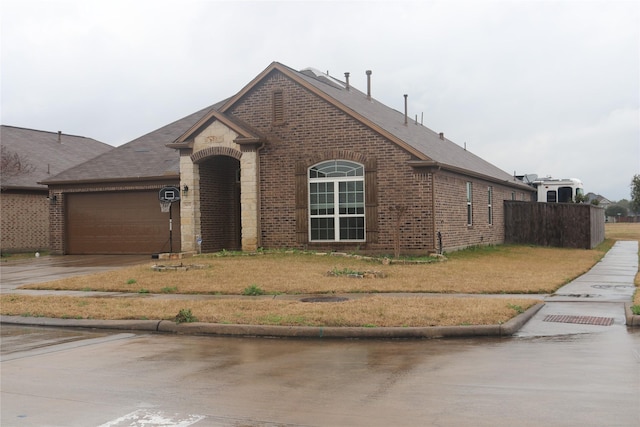 view of front of property with a garage and a front yard