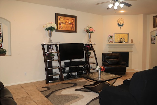 living room featuring light tile patterned floors and ceiling fan