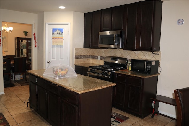 kitchen with tasteful backsplash, appliances with stainless steel finishes, a center island, and dark brown cabinets