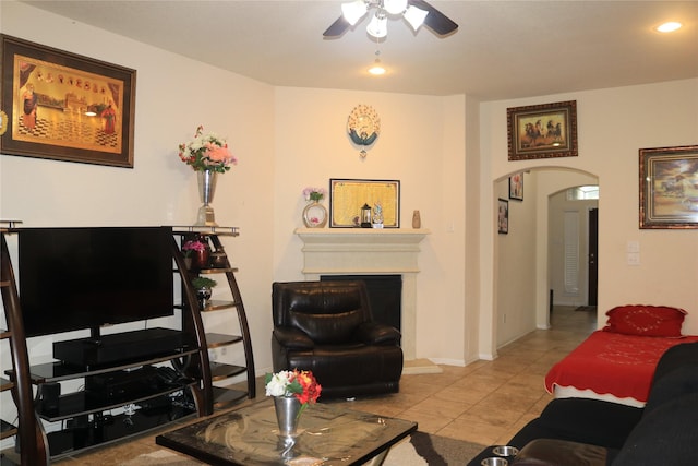 living room featuring light tile patterned floors and ceiling fan