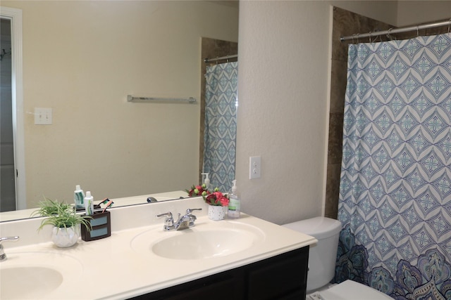 bathroom featuring a shower with curtain, vanity, and toilet