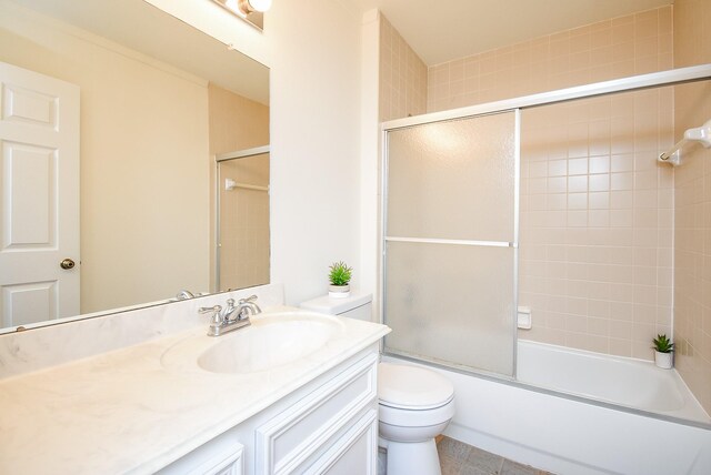 full bathroom with vanity, shower / bath combination with glass door, and toilet