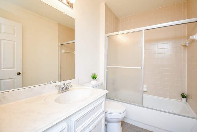 bathroom with combined bath / shower with glass door, vanity, and toilet