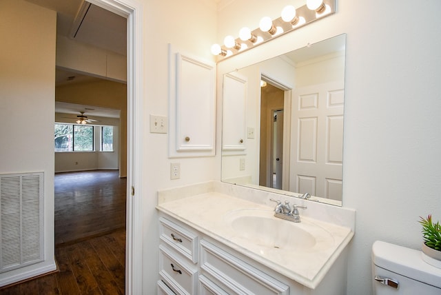 bathroom featuring visible vents, vanity, toilet, and wood finished floors