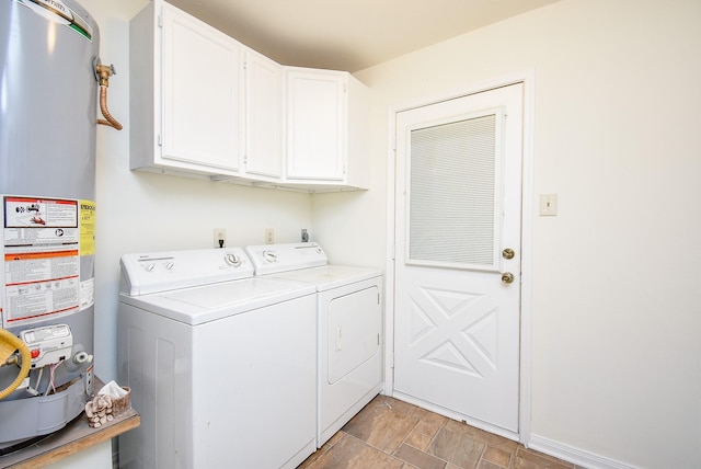 laundry area with cabinets, separate washer and dryer, and water heater