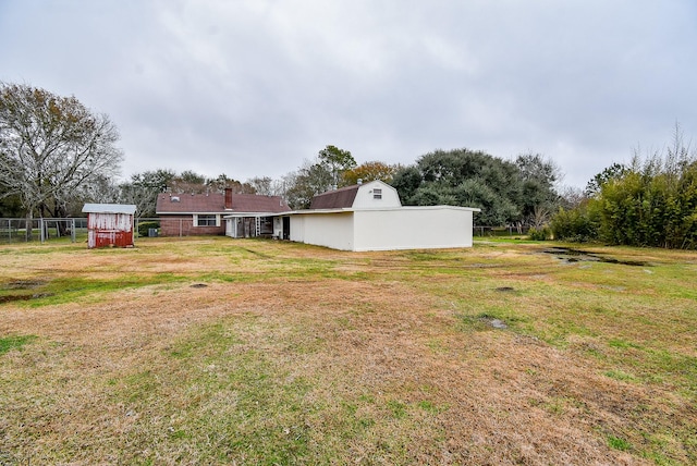 view of yard featuring fence and an outdoor structure