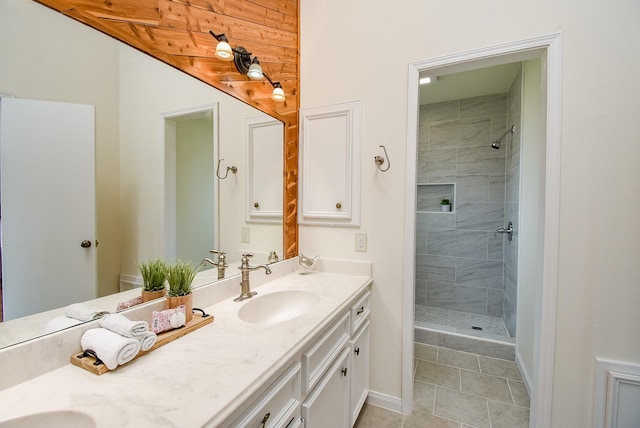 bathroom featuring tiled shower and vanity