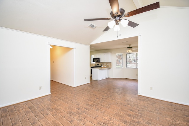 unfurnished living room with vaulted ceiling, ceiling fan, and light hardwood / wood-style floors