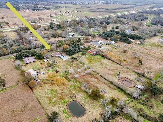 birds eye view of property with a water view and a rural view