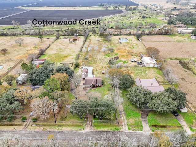 birds eye view of property with a rural view