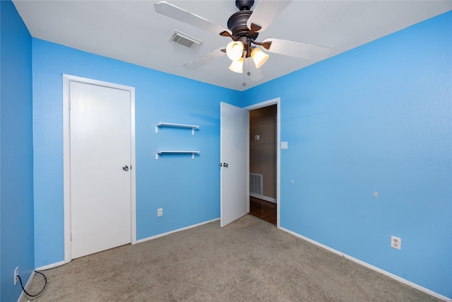 unfurnished bedroom with ceiling fan and light carpet