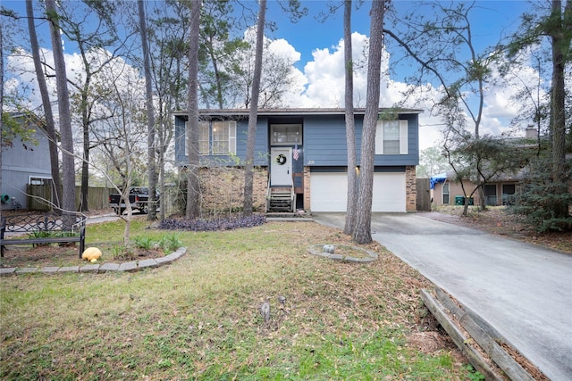 bi-level home with a garage and a front lawn