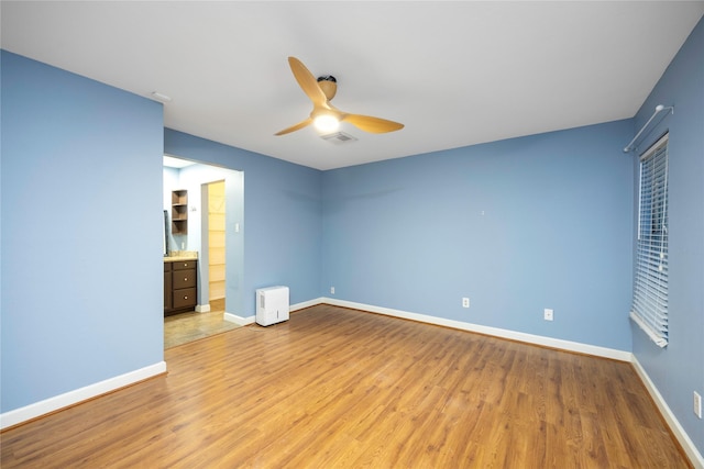 unfurnished bedroom with ceiling fan and light hardwood / wood-style flooring