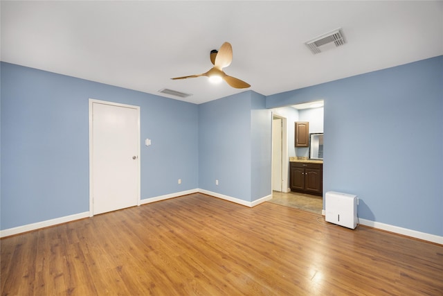 interior space featuring light hardwood / wood-style floors and ceiling fan