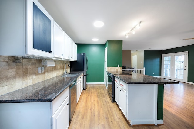 kitchen with sink, black electric range, and white cabinets