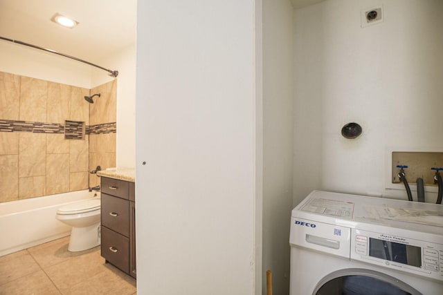 laundry area with washer / dryer and light tile patterned floors