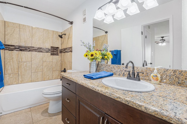 full bathroom with toilet, vanity, tiled shower / bath combo, ceiling fan, and tile patterned flooring