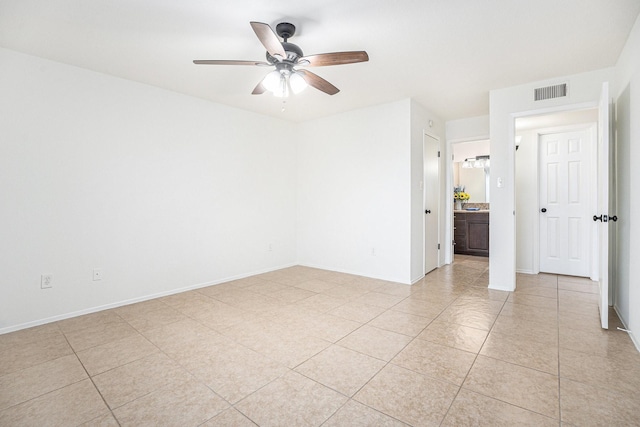 spare room featuring light tile patterned floors and ceiling fan