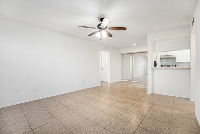 empty room featuring ceiling fan and light tile patterned floors