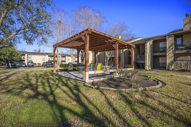 exterior space with a pergola and a lawn