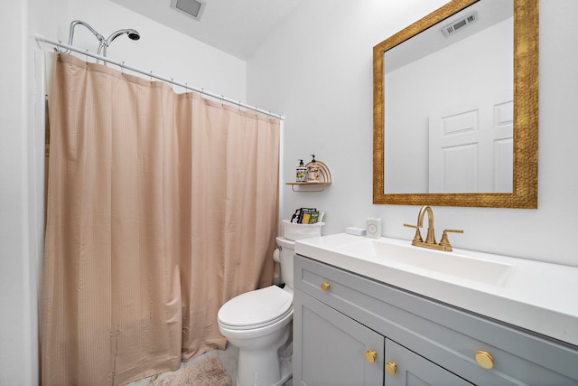 bathroom featuring vanity, a shower with shower curtain, and toilet