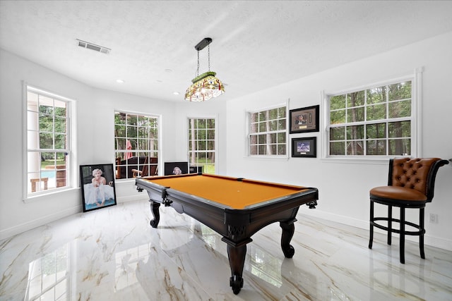 playroom with pool table and a textured ceiling