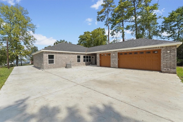 view of front of property with cooling unit and a garage