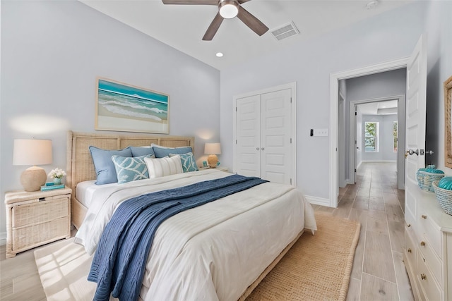 bedroom featuring light hardwood / wood-style floors, a closet, and ceiling fan