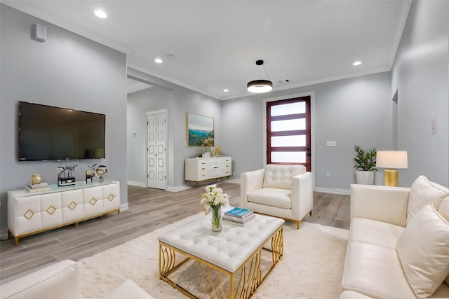 living room with ornamental molding and light wood-type flooring