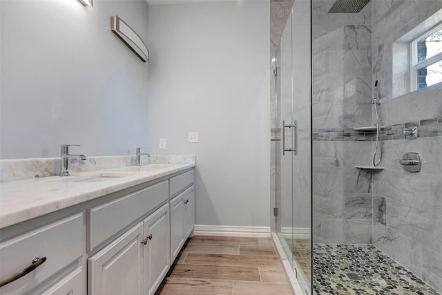 bathroom with walk in shower and vanity