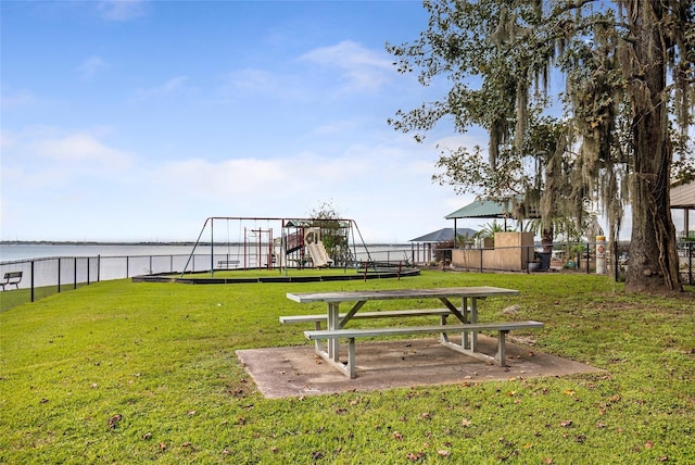 view of yard with a playground and a water view