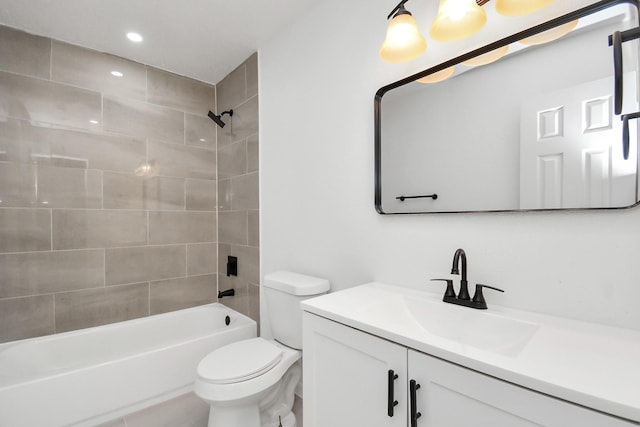 full bathroom featuring vanity, toilet, and tiled shower / bath