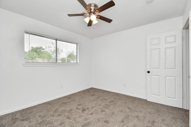 carpeted empty room featuring ceiling fan