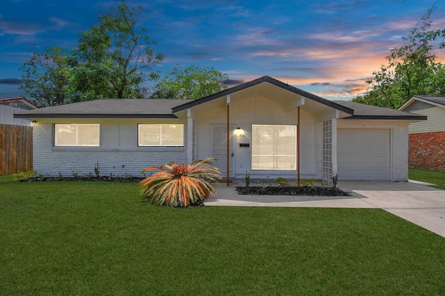 single story home with a garage and a lawn