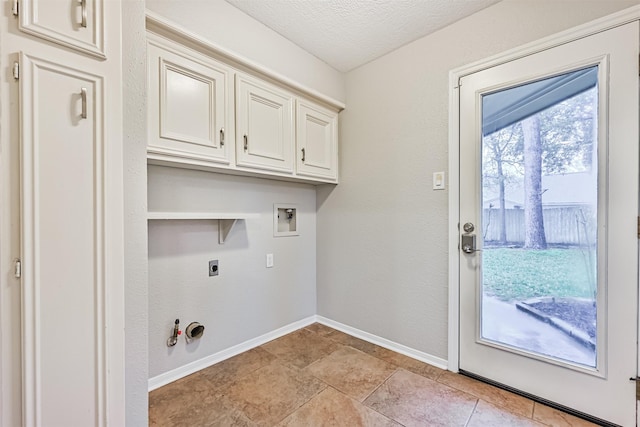 laundry room featuring electric dryer hookup, cabinets, washer hookup, a textured ceiling, and hookup for a gas dryer