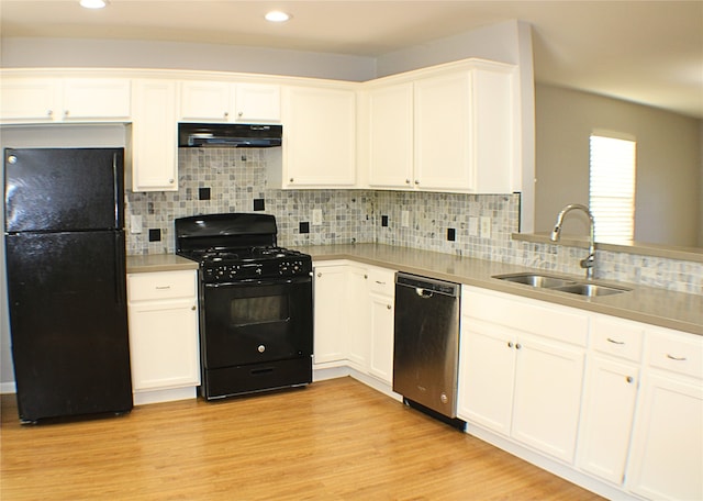 kitchen with white cabinetry, sink, and black appliances