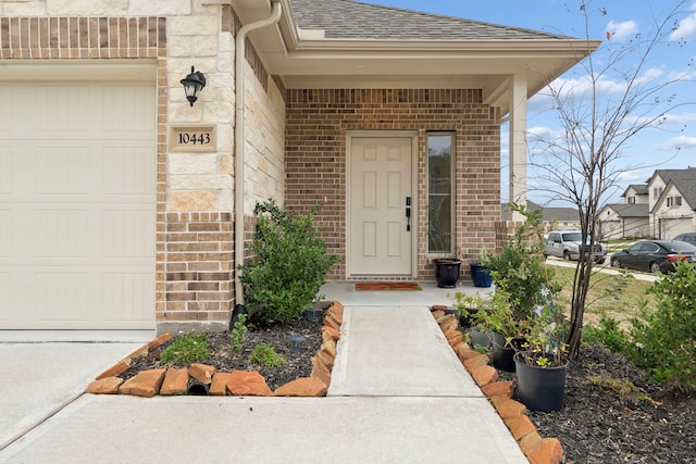 view of exterior entry with a garage