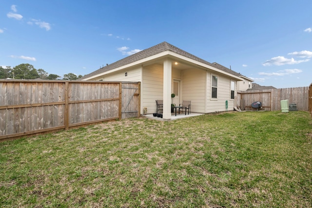 back of property featuring a yard and a patio