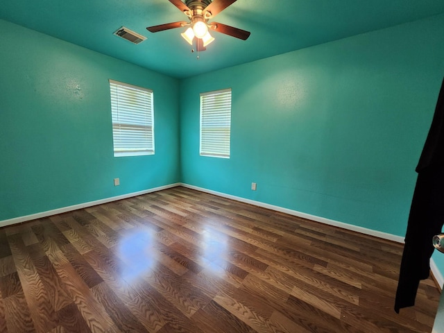 spare room with ceiling fan and dark hardwood / wood-style floors