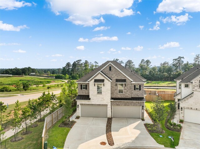 view of front of house with a garage and a front yard