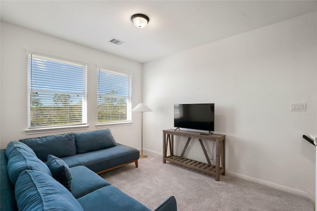 living room featuring light carpet and plenty of natural light