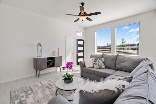 living room featuring light hardwood / wood-style flooring and ceiling fan