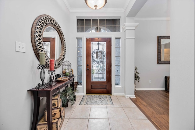 entrance foyer with light tile patterned flooring and crown molding