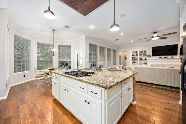 kitchen featuring white cabinetry, a center island, and pendant lighting